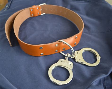 handcuffs from belt|prisoner restraint belt with handcuffs.